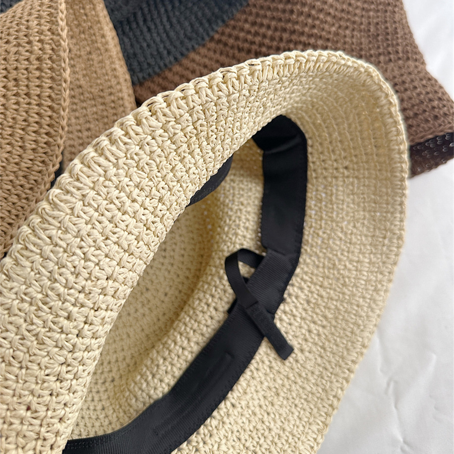 Inside a beige woven bucket hat, showing a black inner band and narrow ribbon