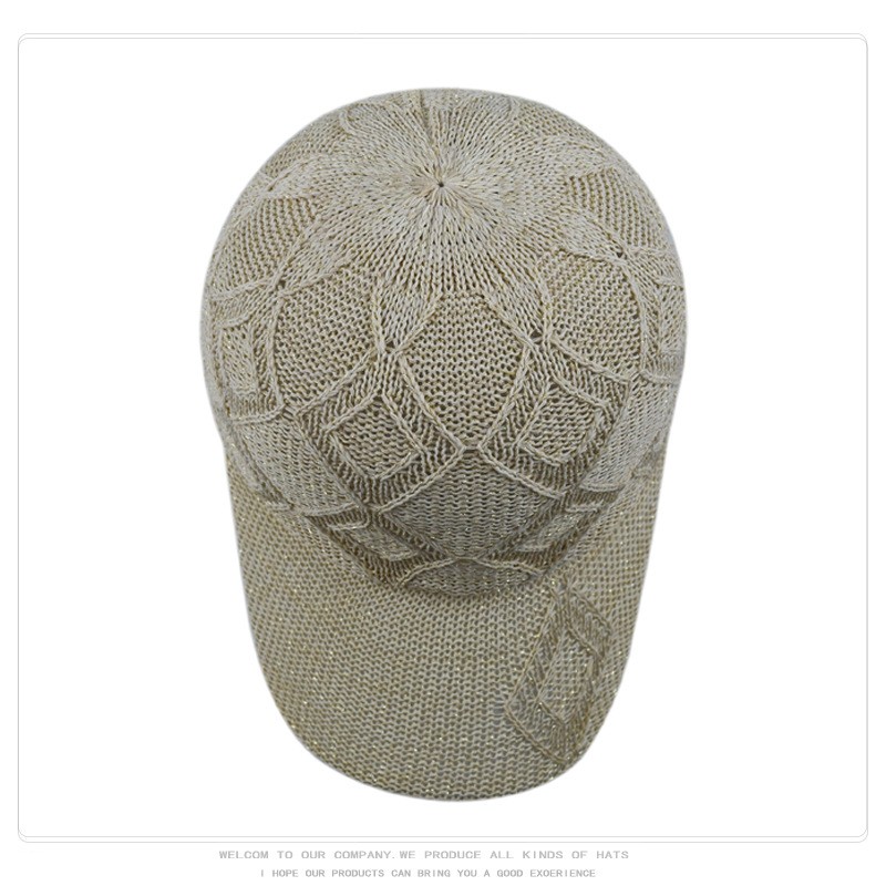 Top view of a beige openwork knit baseball cap with geometric diamond motifs