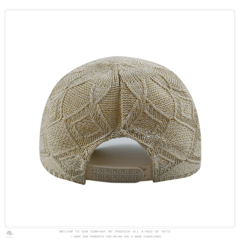 Rear view of a beige openwork knit baseball cap with an adjustable plastic snap closure