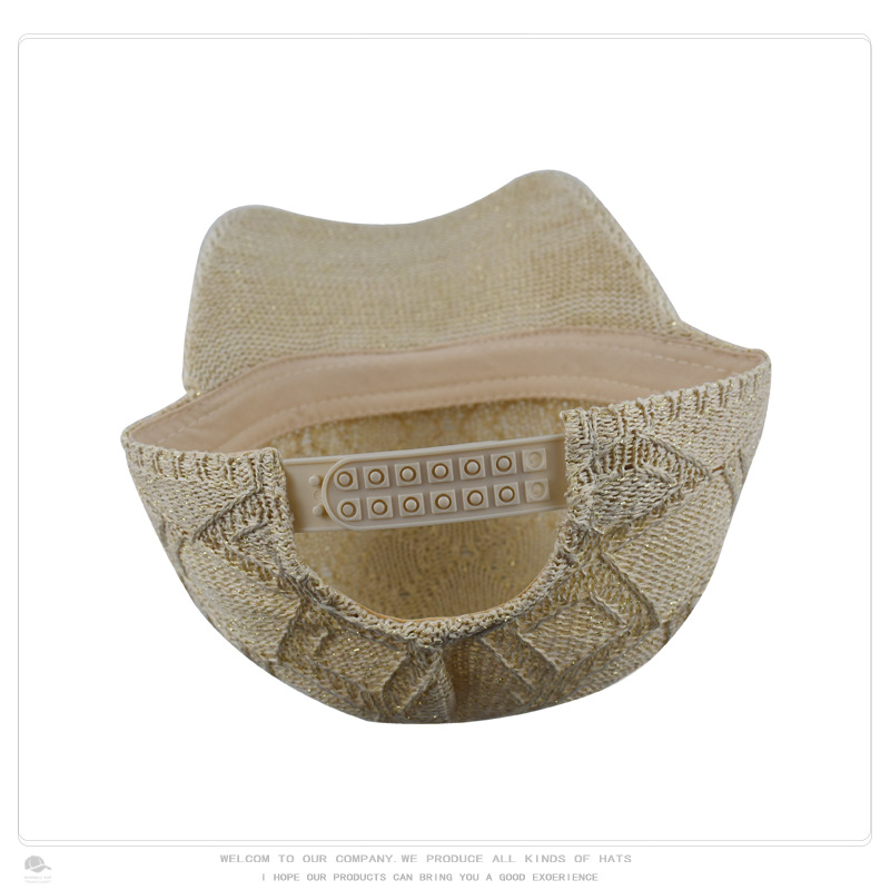 Close rear view of the adjustable snap closure on a beige openwork knit baseball cap