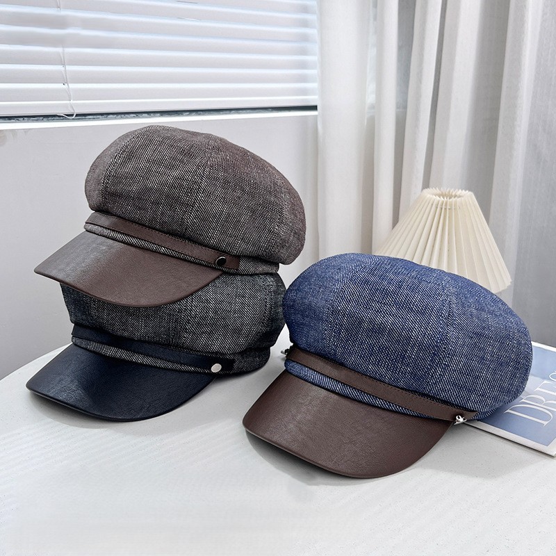 Denim blue newsboy cap with a contrasting brown brim and front band