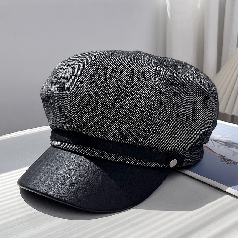 Dark grey denim newsboy cap with black brim and silver-tone side detail