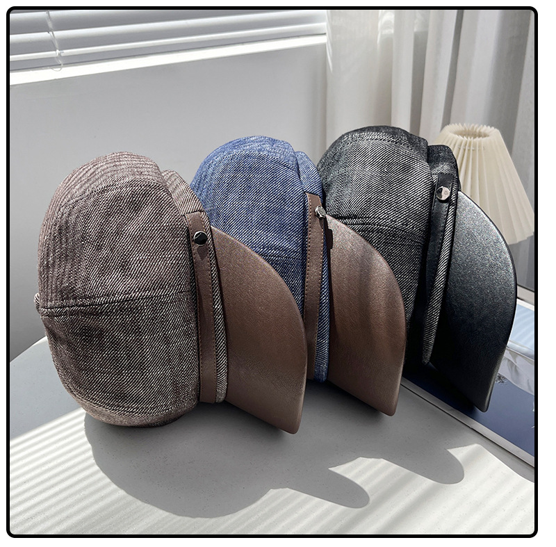 Dark grey, brown and denim blue newsboy caps displayed together