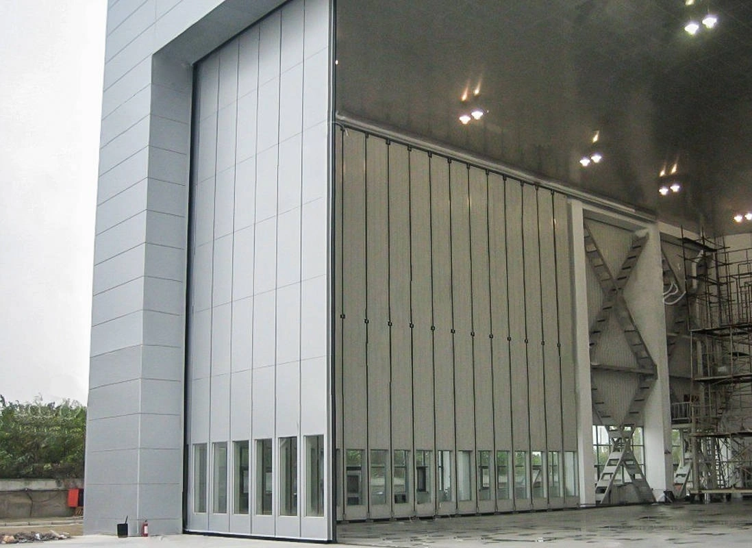 Sliding Hangar Door System with Upper and Lower Rails and Transmission 1