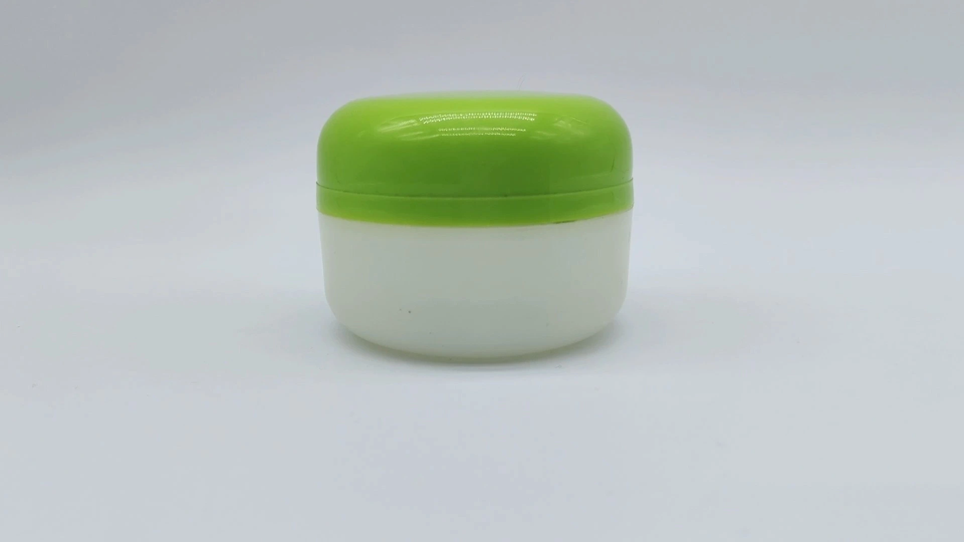 Weit verbreiteter, heißer Verkauf, klassischer Zylinder, anpassbares weißes Glas und polierte grüne Kappe, entworfen für 45 ml Kunststoff-PE-Gesichts-Hand-Hautpflegecreme-Behälter, Kosmetikverpackungsgläser 1