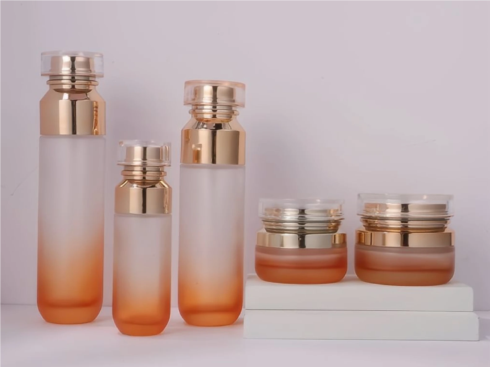 Orange Gradient Skincare Packaging Set with Gold & Crystal Caps | 120/100/40ml Bottles & 50/30g Jars for Revitalizing Lines 1