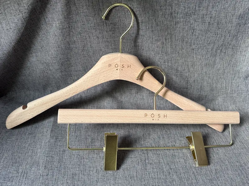 Uncoated painted beech wooden hanger with gold metal 1